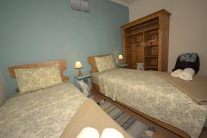 a bedroom with two beds and a dresser at Petrasdream Lefkada in Lefkada
