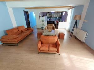 a living room with two couches and a table at Green Wood In Ifari in Kveda-Ipari