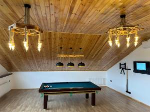 a pool table in a room with a wooden ceiling at Luxury Milan Mountain Ponoramic Villa, indoor heated pool and jacuzzi with mountain view in Gabala