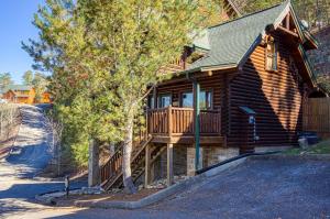 a log cabin with a porch and a deck at Farmers Retreat #221 in Sevierville