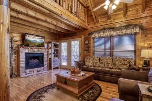 a living room with a couch and a fireplace at Farmers Retreat #221 in Sevierville