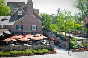 a restaurant with umbrellas in front of a building at Nassau Inn in Princeton