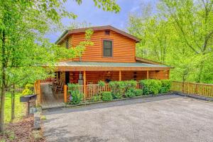 a log cabin with a driveway in front of it at Gone Swimmin' #260 in Pigeon Forge