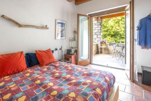 梅尔戈佐La Grubla的带彩色床和露台的卧室