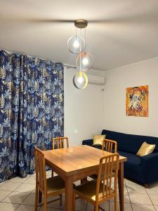 a dining room table with chairs and a blue couch at TreMonti in Guardiagrele +31 photos