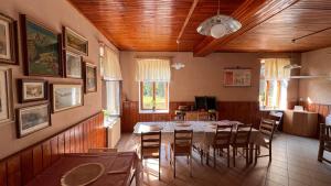 a dining room with a table and chairs at Chata Plechovka in Česká Lípa