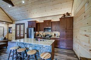 a kitchen with wooden cabinets and a counter with stools at Honey Bear Hill #326 in Sevierville