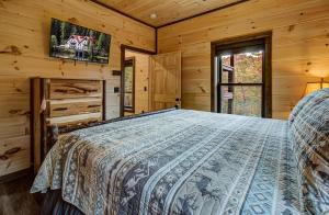 a bedroom with a bed in a log cabin at Honey Bear Hill #326 in Sevierville +54 photos