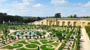 a garden in front of a large building at NinaParis in Les Ulis