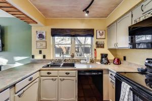 a kitchen with white cabinets and a sink at Willow Bend in Bedford