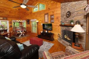 a living room with a fireplace in a log cabin at Jackson's Starry Nite Sky #217 in Sevierville