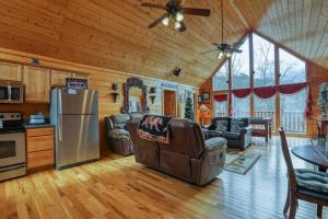 a kitchen and living room with a stainless steel refrigerator at Kissing Retreat #269 in Sevierville