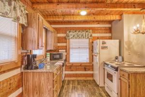 a kitchen with wooden cabinets and a white refrigerator at Leather And Lace #1615 in Gatlinburg