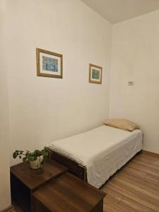ein weißes Zimmer mit einem Bett und einem Tisch in der Unterkunft Feine Wohnung mitten im Zentrum in Kusadası