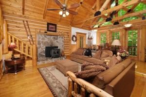 a living room with a couch and a fireplace at Park Paradise #254 in Sevierville