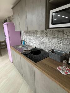 a kitchen with a sink and a stove top oven at Fontanelle Appartaments in Naples +1 photo