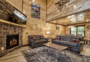 a living room with two couches and a fireplace at Pooling Around #200 in Gatlinburg