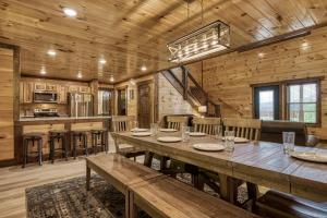 a dining room and kitchen in a log cabin at Pooling Around #200 in Gatlinburg