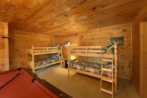 a log cabin with two bunk beds and a pool table at Private Paradise #2810 in Pigeon Forge +17 photos