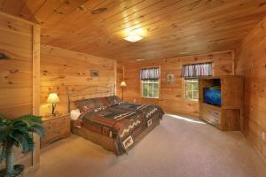 a bedroom with a bed and a television in a cabin at Private Paradise #2810 in Pigeon Forge