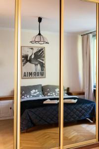 a mirror in a bedroom with a bed in a room at Villa Plater in Olsztyn