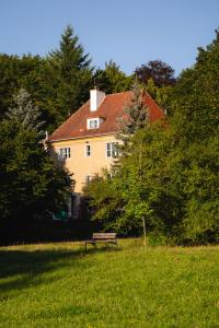 a bench in a field in front of a house at Villa Plater in Olsztyn
