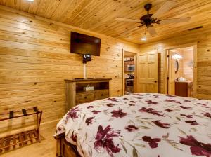a bedroom with a bed and a flat screen tv at River Getaway #2326 in Pigeon Forge