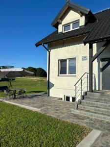 a house with a picnic table and stairs next to a field at Wzgórze nad Jeziorem Blanki in Żegoty +19 photos