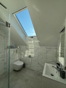 a bathroom with a toilet and a sink and a window at Wzgórze nad Jeziorem Blanki in Żegoty