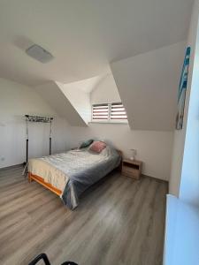 a bedroom with a bed in a attic at Wzgórze nad Jeziorem Blanki in Żegoty