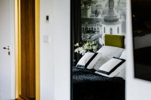 a bedroom with a bed with two pillows at APARTAMENTY ARTE LUBLIN Unia Art Residence 121- faktura VAT garaż in Lublin +14 photos