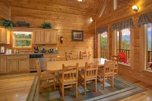 a dining room with a table and chairs in a cabin at Splash Mansion #500 in Gatlinburg
