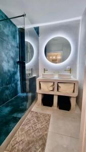 a bathroom with a sink and a mirror and a shower at Cosy family spa Strasbourg center in Strasbourg