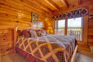 a bedroom with a bed in a log cabin at Starry Nights #222 in Pigeon Forge +17 photos