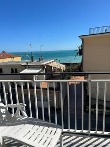 a deck with chairs and a view of the ocean at Casa Lora con spiaggia RDA luxury in Bordighera +6 photos