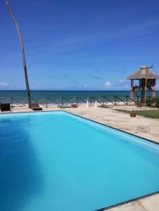 a swimming pool with the ocean in the background at Eco Paradise 213 in Cumbuco