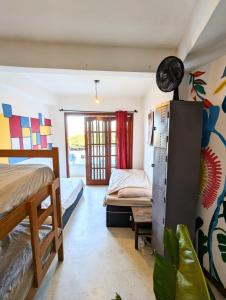 a bedroom with two beds and a window at La Bohème Casa Cultural - Santa Teresa in Rio de Janeiro