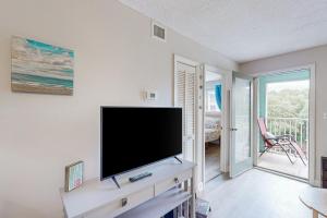 a living room with a flat screen tv at Hilton Head Resort 3308 in Hilton Head Island