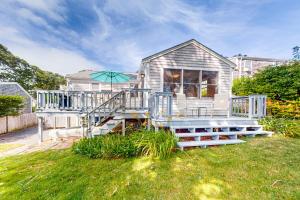 a house with a deck and an umbrella at Yarmouth Bliss in Yarmouth