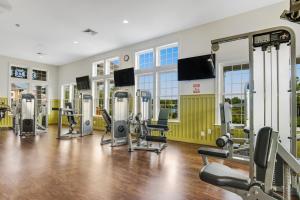 a gym with treadmills and exercise equipment in a building at Millville by the Sea --- 35015 Sunfish Ln in Millville