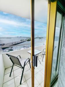 a balcony with a table and chairs and a view of the ocean at Bayfront Apartment Breathtaking Views- one bedroom w balcony- living room -Free Parking in Miami Beach