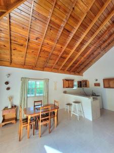 a kitchen and dining room with a wooden ceiling at Green's Palace Jamaica in Oracabessa