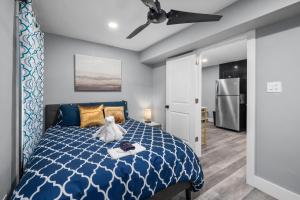 a bedroom with a blue bed with a teddy bear on it at Houston Heights 2BR Getaway with Pool & Free Park in Houston +14 photos