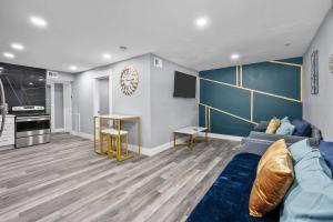a living room with a blue couch and a kitchen at Houston Heights 2BR Getaway with Pool & Free Park in Houston