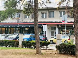 a parking lot with cars parked in front of a building at Golden Oasis in Belgrade