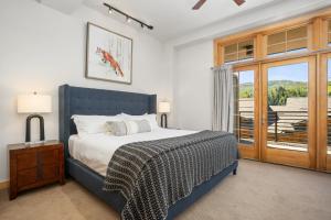 a bedroom with a bed and a large window at Urban Loft in Downtown Steamboat - Upscale Luxury in Steamboat Springs
