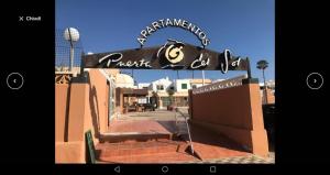 a building with a sign on the side of it at Appartamento Puerta del Sol in Caleta De Fuste