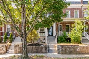 a brick house with stairs and a tree at Renovated 5BR DC Home Naer Capitol Area Free Parking in Washington
