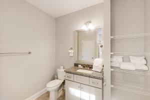 a white bathroom with a toilet and a sink at Old Bryan Salento - B in Myrtle Beach +14 photos