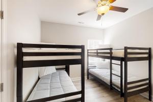two bunk beds in a room with a ceiling fan at Old Bryan Salento - B in Myrtle Beach